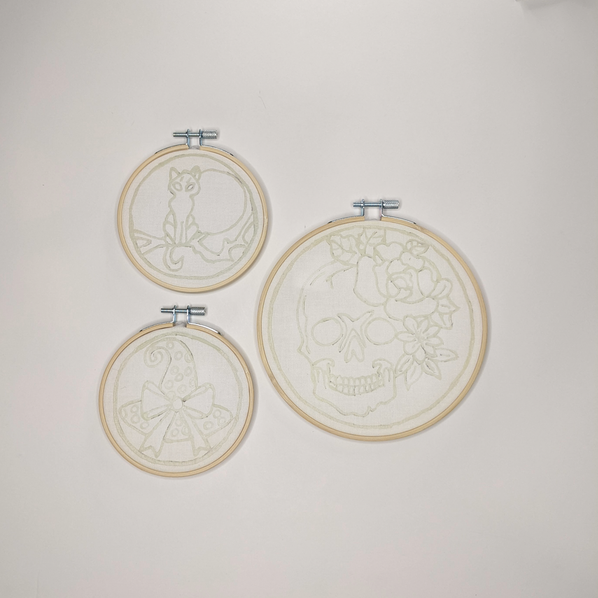 Three hoops with pre-waxed designs of skull with rose, moonlit cat and witch's hat.